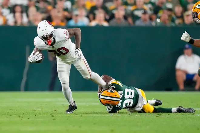 Aug 28, 2026; Green Bay, Wisconsin, USA;  Arizona Cardinals cornerback Quinton Newsome (30) is tackled by Green Bay Packers cornerback Jaylin Simpson (38) during the second quarter at Lambeau Field. Mandatory Credit: Jeff Hanisch-Imagn Images