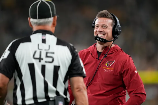 Aug 28, 2026; Green Bay, Wisconsin, USA;  Arizona Cardinals head coach Mike LaFleur talks with line judge Jeff Seeman (45) during the third quarter against the Green Bay Packers at Lambeau Field. Mandatory Credit: Jeff Hanisch-Imagn Images