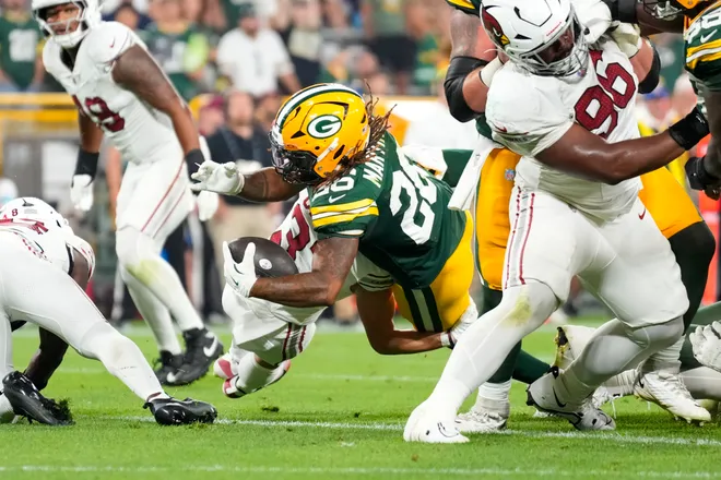 Aug 28, 2026; Green Bay, Wisconsin, USA;  Green Bay Packers running back Damien Martinez (26) scores a two point conversion during the fourth quarter against the Arizona Cardinals at Lambeau Field. Mandatory Credit: Jeff Hanisch-Imagn Images