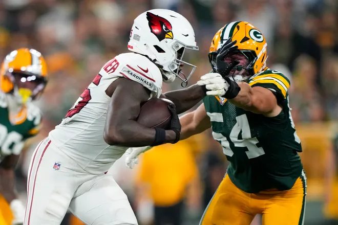 Aug 28, 2026; Green Bay, Wisconsin, USA;  Arizona Cardinals tight end Rivaldo Fairweather (45) stiff arms Green Bay Packers linebacker Kristian Welch (54) during the fourth quarter at Lambeau Field. Mandatory Credit: Jeff Hanisch-Imagn Images