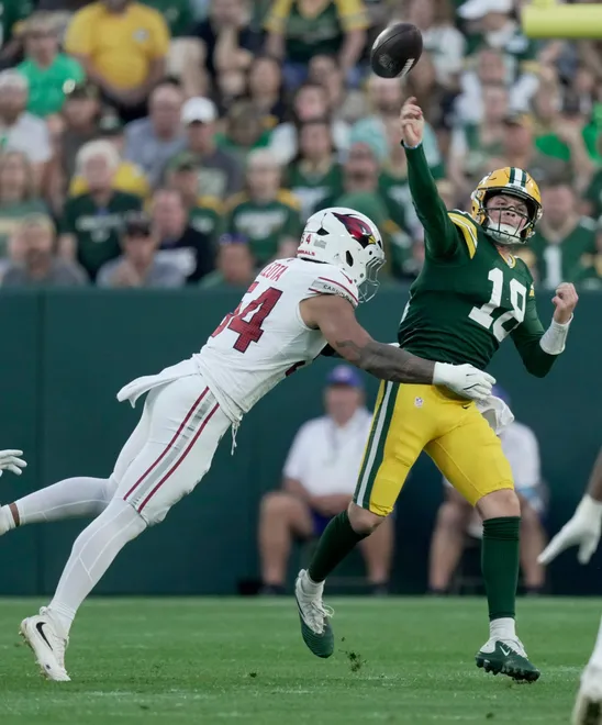 Green Bay Packers quarterback Kyle McCord (18) is pressured by Arizona Cardinals linebacker Eku Leota (54) during the first quarter of their preseason game Friday, August 28, 2026 at Lambeau Field in Green Bay, Wisconsin.