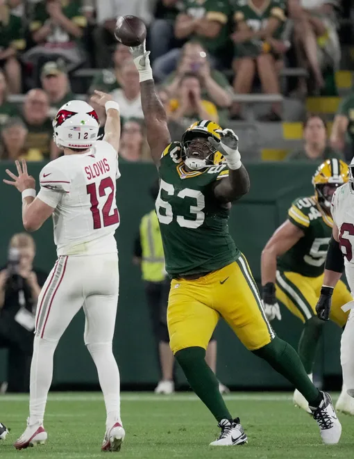 Green Bay Packers defensive tackle Jaden Crumedy (63) pressures Arizona Cardinals quarterback Kedon Slovis (12) during the third quarter of their preseason game Friday, August 28, 2026 at Lambeau Field in Green Bay, Wisconsin.