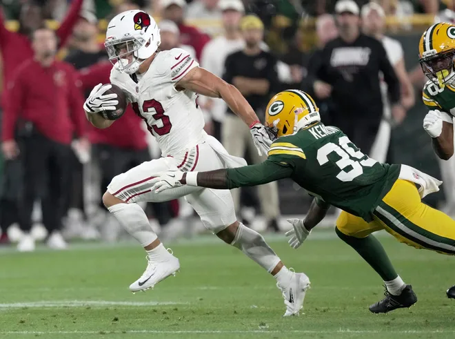 Arizona Cardinals running back Evan Hull (43) runs for a 47-yard touchdown after Green Bay Packers safety Murvin Kenion III (39) misses a tackle during the second quarter of their preseason game Friday, August 28, 2026 at Lambeau Field in Green Bay, Wisconsin.