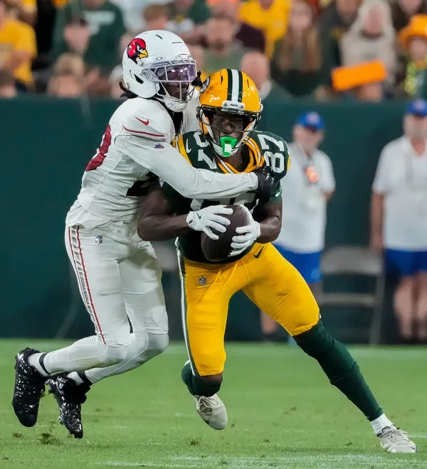 Green Bay Packers wide receiver J. Michael Sturdivant (87)  is hit by Arizona Cardinals cornerback Elijah Jones (28) as he catches a pass during their preseason football game on Friday, Aug. 28, 2026, at Lambeau Field in Green Bay, Wisconsin. The Packers won the game, 42-38.
Tork Mason/Green Bay Press-Gazette