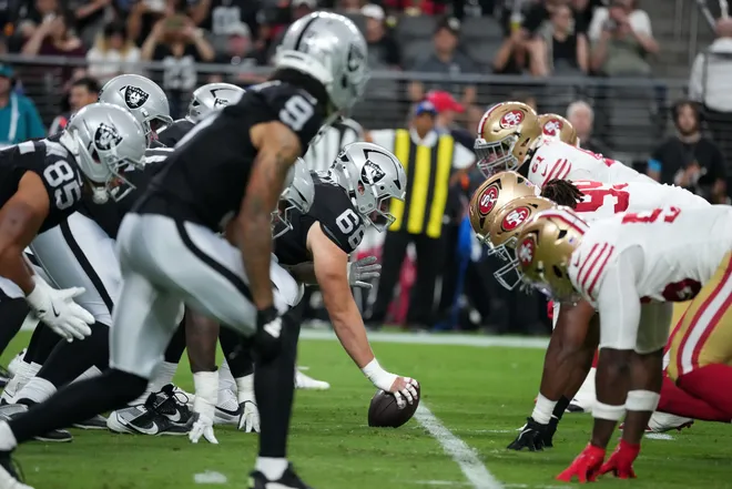 Aug 27, 2026; Paradise, Nevada, USA; Helmets at the line of scrimmage as Las Vegas Raiders center Trey Zuhn III (66) snaps the ball against the San Francisco 49ers at Allegiant Stadium. Mandatory Credit: Kirby Lee-Imagn Images