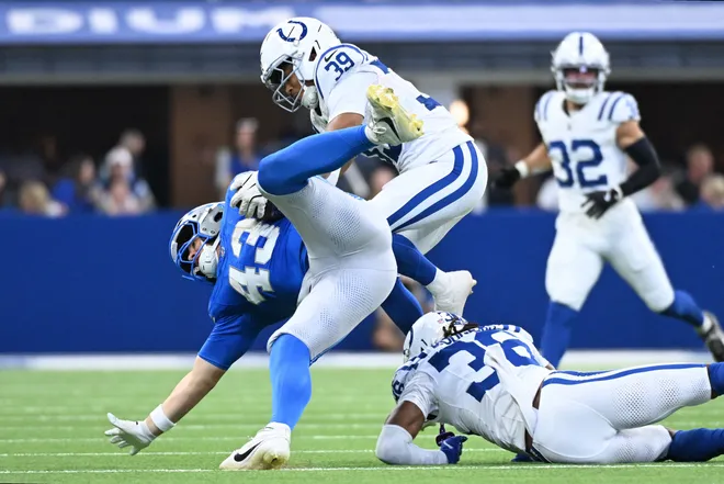 Aug 29, 2026; Indianapolis, Indiana, USA;  Indianapolis Colts safety Jonathan Owens (38) trips up Detroit Lions tight end Zach Horton (43) during the second half at Lucas Oil Stadium.  Mandatory Credit: Robert Goddin-Imagn Images