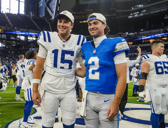 Indianapolis Colts quarterback Riley Leonard (15) and Detroit Lions cornerback Ennis Rakestraw Jr. (2) smile for a photo together Saturday, Aug. 29, 2026, during the game against the Detroit Lions at Lucas Oil Stadium in Indianapolis. The Detroit Lions defeated the Indianapolis Colts, 25-16.