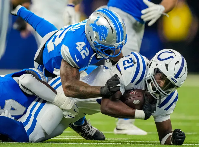 Indianapolis Colts running back DJ Giddens (21) is brought down by Detroit Lions defensive back Aamaris Brown (42) on Saturday, Aug. 29, 2026, during the game against the Detroit Lions at Lucas Oil Stadium in Indianapolis. The Detroit Lions defeated the Indianapolis Colts, 25-16.