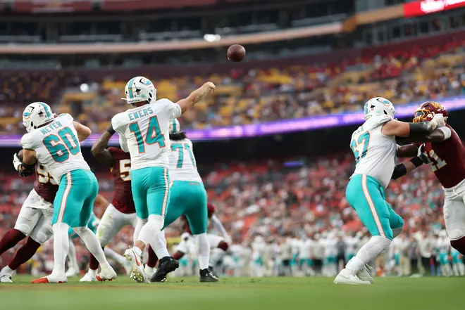 Aug 14, 2026; Landover, Maryland, USA; Miami Dolphins quarterback Quinn Ewers (14) passes the ball against the Washington Commanders during the first half at Northwest Stadium. Mandatory Credit: Geoff Burke-Imagn Images