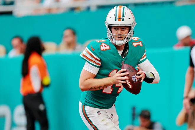 Dec 21, 2025; Miami Gardens, Florida, USA; Miami Dolphins quarterback Quinn Ewers (14) runs the ball during the fourth quarter against the Cincinnati Bengals at Hard Rock Stadium. Mandatory Credit: Sam Navarro-Imagn Images