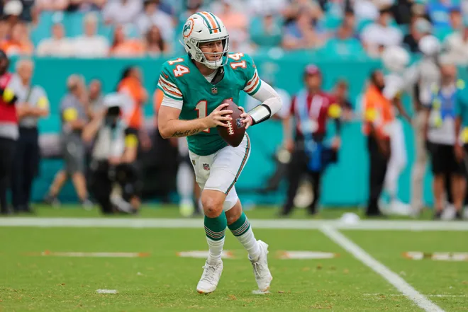 Dec 21, 2025; Miami Gardens, Florida, USA; Miami Dolphins quarterback Quinn Ewers (14) runs the ball during the third quarter against the Cincinnati Bengals at Hard Rock Stadium. Mandatory Credit: Sam Navarro-Imagn Images