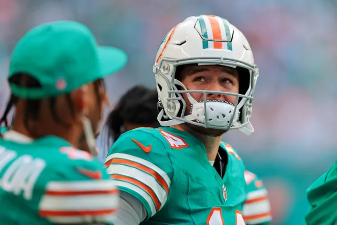 Dec 21, 2025; Miami Gardens, Florida, USA; Miami Dolphins quarterback Quinn Ewers (14) looks on from the sideline during the second quarter against the Cincinnati Bengals at Hard Rock Stadium. Mandatory Credit: Sam Navarro-Imagn Images