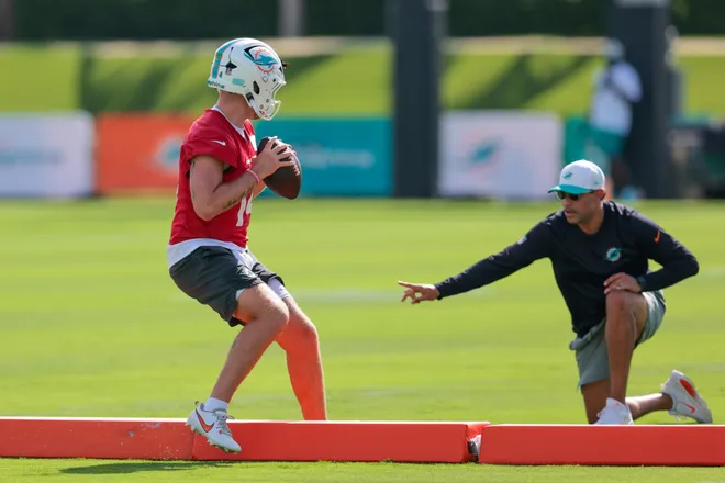Jul 29, 2026; Miami Gardens, FL, USA; Miami Dolphins quarterback coach Bush Hamdan works with quarterback Quinn Ewers (14) during practice at Baptist Health Training Complex. Mandatory Credit: Sam Navarro-Imagn Images