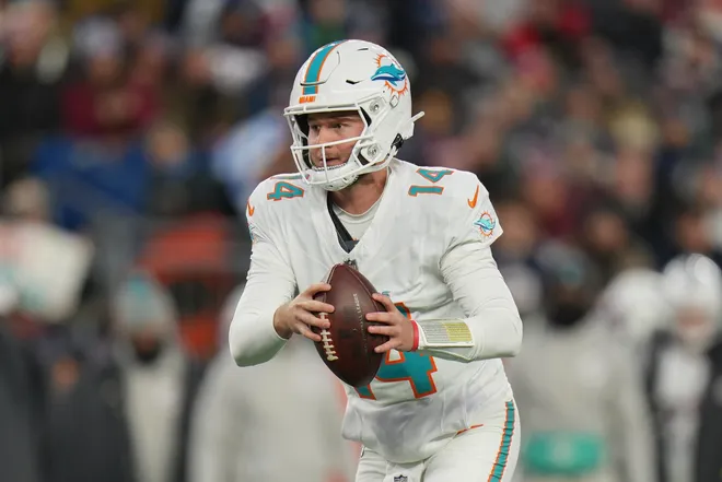 Jan 4, 2026; Foxborough, Massachusetts, USA; Miami Dolphins quarterback Quinn Ewers (14) looks to hand the ball off to a teammate against the New England Patriots  during the first quarter at Gillette Stadium. Mandatory Credit: David Butler II-Imagn Images