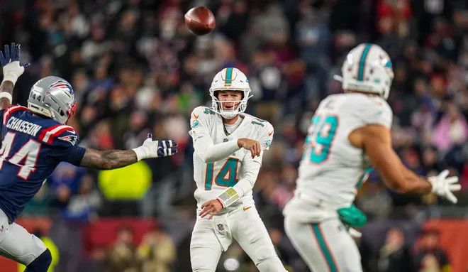 Jan 4, 2026; Foxborough, Massachusetts, USA; Miami Dolphins quarterback Quinn Ewers (14) throws a pass intended for tight end Julian Hill (89) against New England Patriots linebacker K'Lavon Chaisson (44) during the second quarter at Gillette Stadium. Mandatory Credit: David Butler II-Imagn Images
