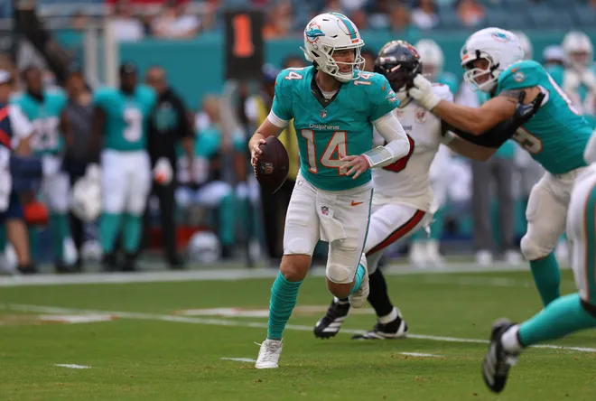 Dec 28, 2025; Miami Gardens, Florida, USA; Miami Dolphins quarterback Quinn Ewers (14) runs in the pocket during the first quarter against the Tampa Bay Buccaneers at Hard Rock Stadium. Mandatory Credit: Nathan Ray Seebeck-Imagn Images