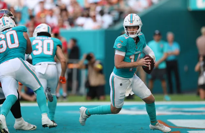 Dec 28, 2025; Miami Gardens, Florida, USA; Miami Dolphins quarterback Quinn Ewers (14) runs in the pocket during the fourth quarter against the Tampa Bay Buccaneers at Hard Rock Stadium. Mandatory Credit: Nathan Ray Seebeck-Imagn Images
