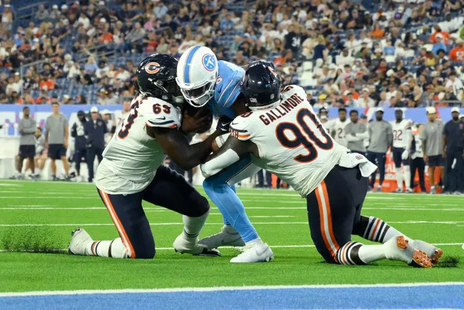 Aug 29, 2026; Nashville, Tennessee, USA;  Chicago Bears defensive end Jeremiah Martin (69) and defensive tackle Neville Gallimore (90) tackle Tennessee Titans quarterback Hendon Hooker (16) during the fourth quarter at Nissan Stadium.  Mandatory Credit: Steve Roberts-Imagn Images