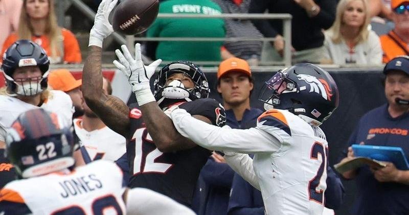 Nov 2, 2025; Houston, Texas, USA; Houston Texans wide receiver Nico Collins (12) makes a catch against Denver Broncos cornerback Riley Moss (21) during the first half at NRG Stadium. Mandatory Credit: Thomas Shea-Imagn Images | State