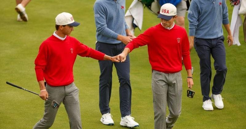 Miles Russell (USA), left, gives U.S. National Junior Team member Tyler Watts a fist bump after winning the fifth hole during foursomes matches of the 2026 Walker Cup at Lahinch in County Clare, Republic of Ireland on Sunday, Sept. 6, 2026. | National