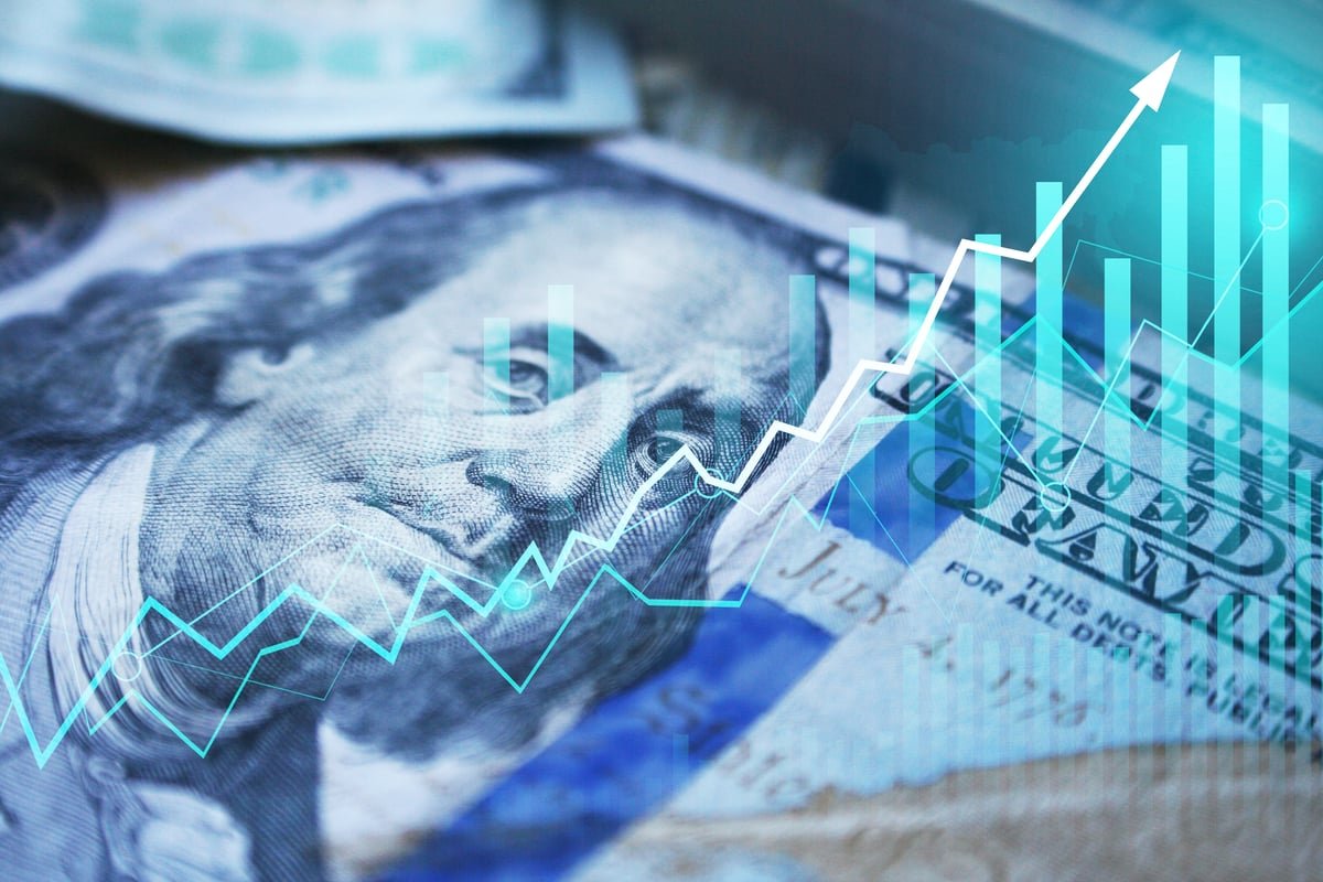 A hundred-dollar bill and chart lines.