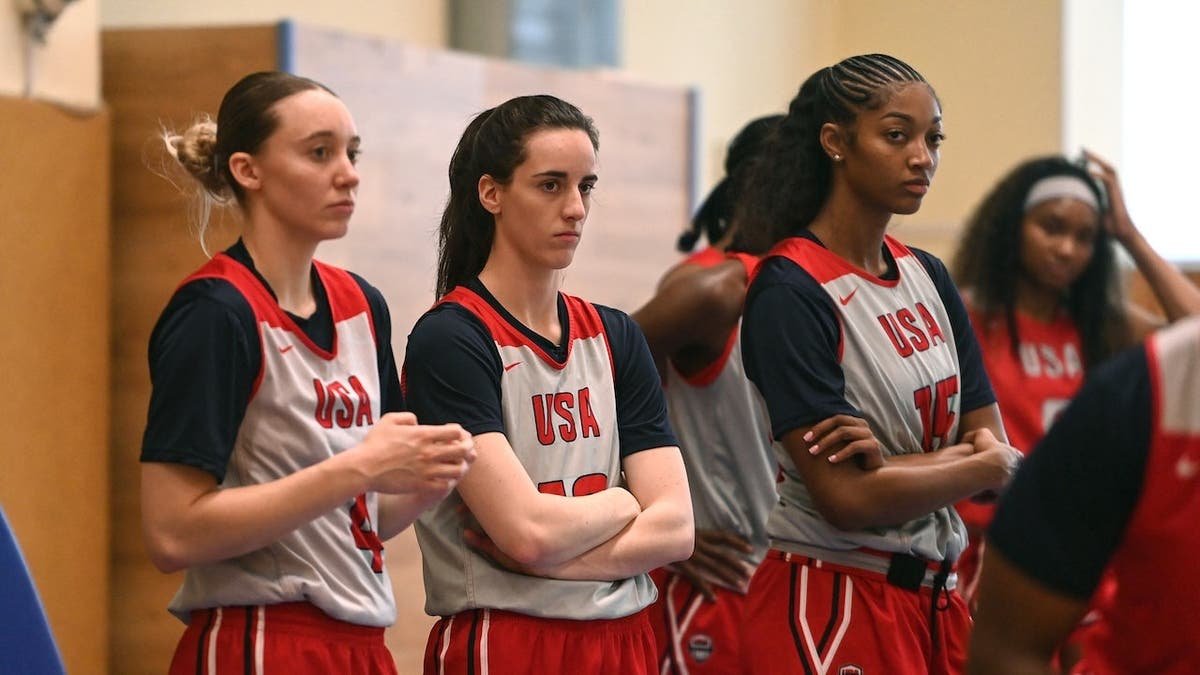 Paige Bueckers, Caitlin Clark and Angel Reese look on during practice.