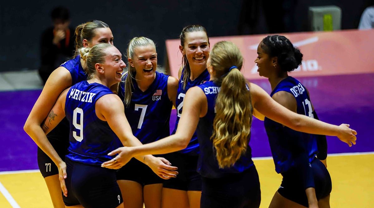 The U.S. Women's National Team members huddle in celebration on the court