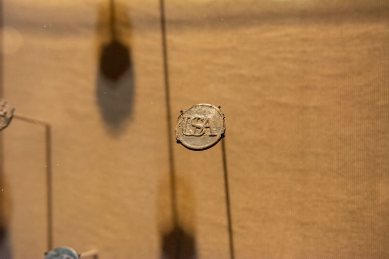 A Revolutionary-era military mark with the stamp USA on display at the Museum of the American Revolution. This is one of the first impressions that reads "USA."