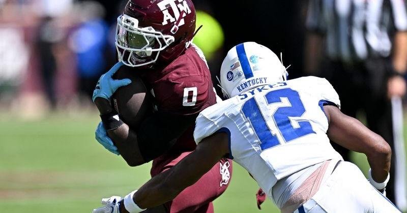 Sep 19, 2026; College Station, Texas, USA; Texas A&M Aggies running back KJ Edwards (0) runs the ball as Kentucky Wildcats defensive back Hasaan Sykes (12) defends at Kyle Field. Mandatory Credit: Maria Lysaker-Imagn Images | State