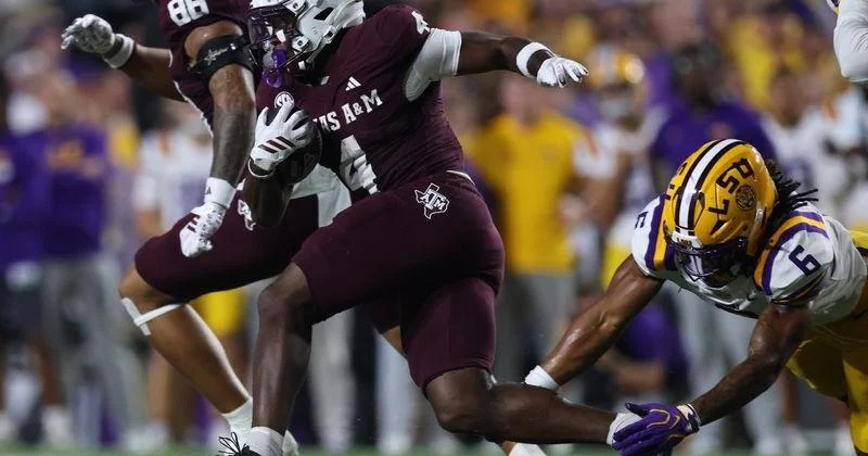 Sep 26, 2026; Baton Rouge, Louisiana, USA; Texas A&M Aggies running back Rueben Owens II (4) runs the ball as LSU Tigers linebacker TJ Dottery (6) attempts to tackle during the second quarter at Tiger Stadium. Mandatory Credit: Stephen Lew-Imagn Images | Texas