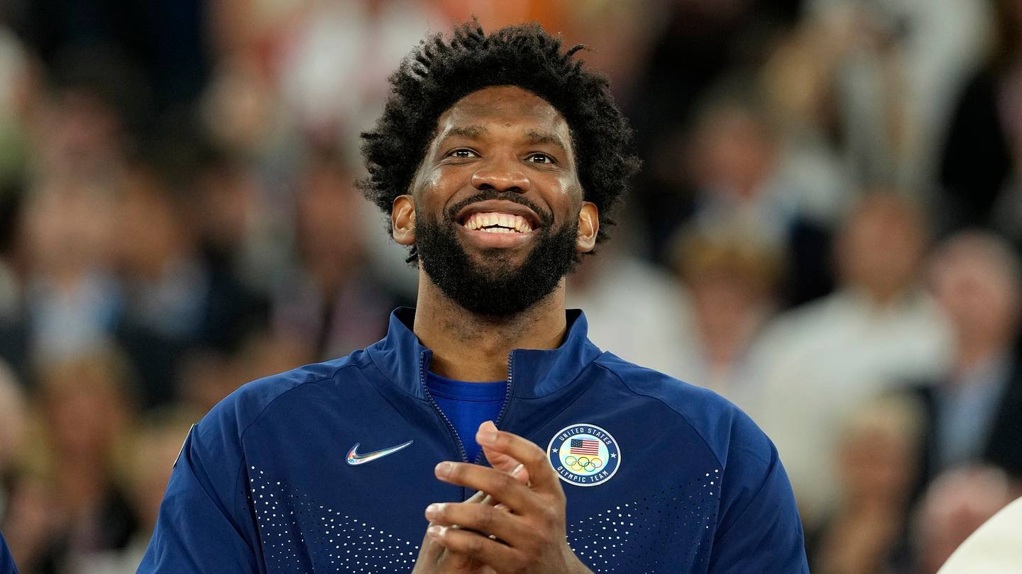 United States centre Joel Embiid (11) celebrates with the gold medal after the game against France in the men's basketball gold medal game during the Paris 2024 Olympic Summer Games at Accor Arena on Aug. 10, 2024