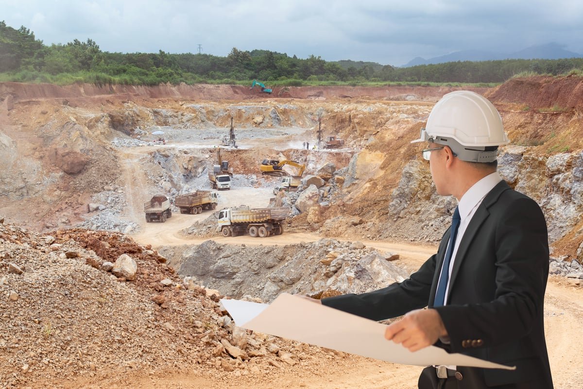 A businesspersons oversees operations in a mine.