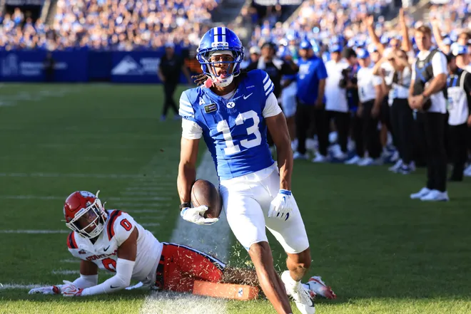 Sep 5, 2026; Provo, Utah, USA;  BYU Cougars wide receiver Jojo Phillips (13) runs a catch in for a touchdown against Utah Tech Trailblazers defensive back Jeremiah Jimoh (0) during the first quarter at LaVell Edwards Stadium.  Mandatory Credit: Rob Gray-Imagn Images