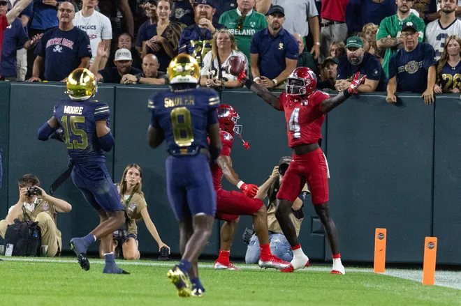 Sep 6, 2026; Green Bay, Wisconsin, USA;  Wisconsin Badgers wide receiver Malachi Coleman (4) reacts after making a catch for a touchdown against the Notre Dame Fighting Irish in the first half at Lambeau Field.  Mandatory Credit: Trevor Ruszkowski-Imagn Images