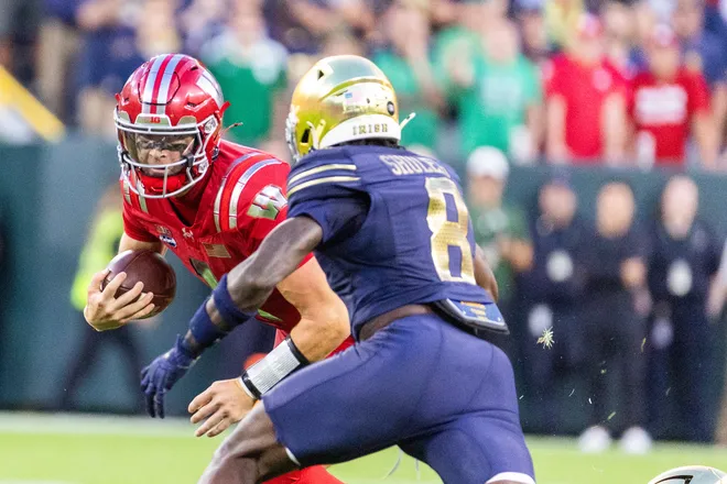 Sep 6, 2026; Green Bay, Wisconsin, USA;  Wisconsin Badgers quarterback Colton Joseph (1) rushes the ball against Notre Dame Fighting Irish safety Adon Shuler (8) in the first half at Lambeau Field.  Mandatory Credit: Trevor Ruszkowski-Imagn Images