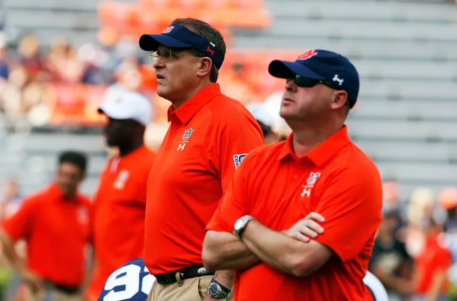 Sep 29, 2018; Auburn, AL, USA; Auburn Tigers head coach Gus Malzahn (left) and offensive coordinator Chip Lindsey (right) watch the team warm up prior to the game against the Southern Miss Golden Eagles at Jordan-Hare Stadium. Mandatory Credit: John Reed-USA TODAY Sports