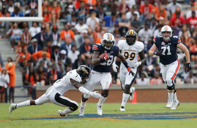 Sep 29, 2018; Auburn, AL, USA; Auburn Tigers running back JaTarvious Whitlow (28) is tackled by Southern Miss Golden Eagles defensive back Ty Williams (7) during the second quarter at Jordan-Hare Stadium. Mandatory Credit: John Reed-USA TODAY Sports
