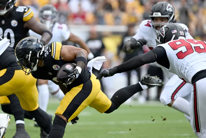 Sep 13, 2026; Pittsburgh, Pennsylvania, USA;  Pittsburgh Steelers running back Jaylen Warren (30) runs against Atlanta Falcons defensive end Cameron Thomas (99) during the first quarter at Acrisure Stadium.  Mandatory Credit: Barry Reeger-Imagn Images