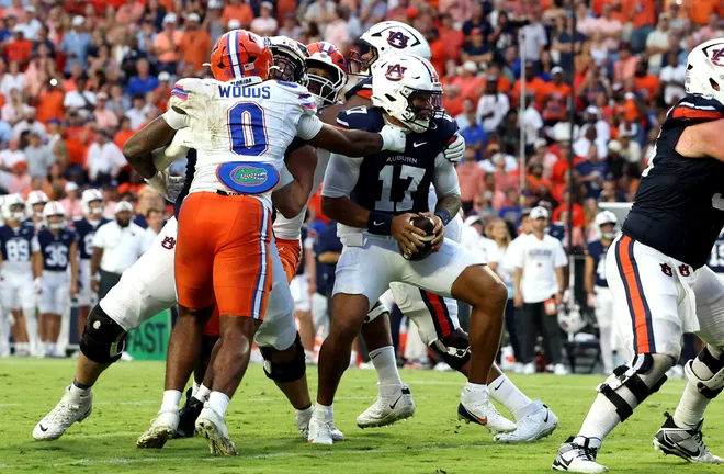 Sep 19, 2026; Auburn, Alabama, USA;  Florida Gators safety Cam Dooley (10) grabs Auburn Tigers quarterback Byrum Brown (17) during the first quarter at Jordan-Hare Stadium.  Mandatory Credit: John Reed-Imagn Images