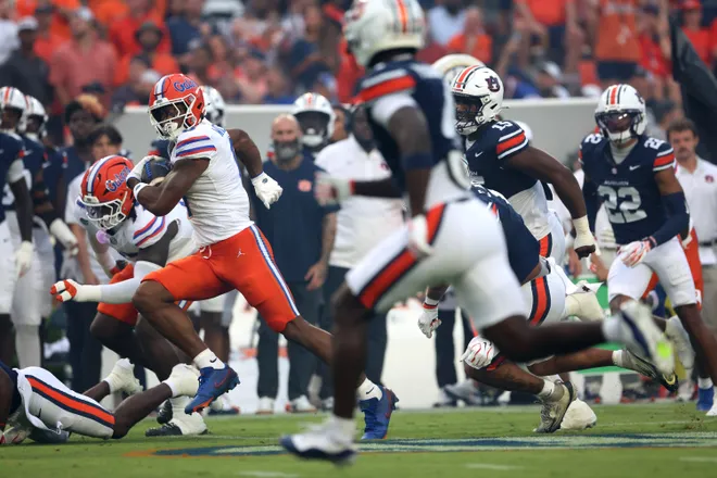 Sep 19, 2026; Auburn, Alabama, USA;  Florida Gators wide receiver Dallas Wilson (6) runs against Auburn Tigers defenders during the first quarter at Jordan-Hare Stadium.  Mandatory Credit: John Reed-Imagn Images