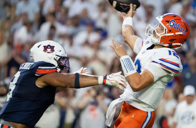 Florida Gators quarterback Aaron Philo (12) throws the ball with pressure from Auburn Tigers linebacker Elijah Melendez (9) as Auburn Tigers take on Florida Gators at Jordan-Hare Stadium in Auburn, Ala. on Saturday, Sept. 19, 2026.