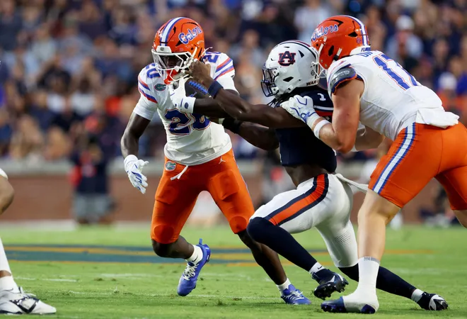 Sep 19, 2026; Auburn, Alabama, USA;  Auburn Tigers defensive back Champ Anthony (1) moves in to tackle Florida Gators running back Duke Clark (20) during the first quarter at Jordan-Hare Stadium.  Mandatory Credit: John Reed-Imagn Images