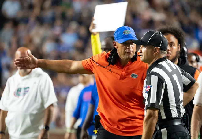 Florida Gators head coach Jon Sumrall disputes a call with the official as Auburn Tigers take on Florida Gators at Jordan-Hare Stadium in Auburn, Ala. on Saturday, Sept. 19, 2026. Florida Gators lead Auburn Tigers 20-17 at halftime.