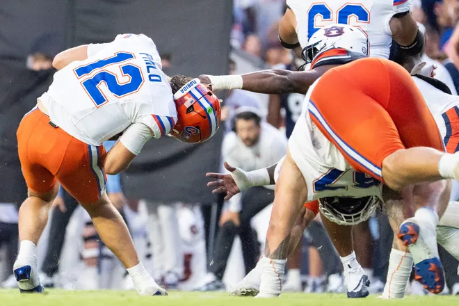 Florida Gators quarterback Aaron Philo (12) avoids a sack from Auburn Tigers edge Da'Shawn Womack (15) as Auburn Tigers take on Florida Gators at Jordan-Hare Stadium in Auburn, Ala. on Saturday, Sept. 19, 2026.