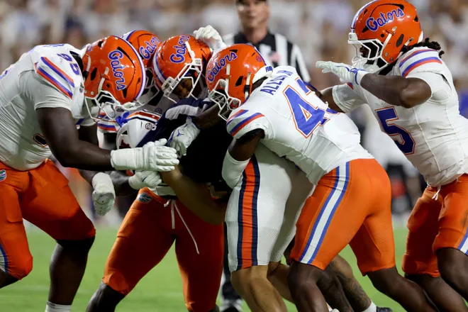 Sep 19, 2026; Auburn, Alabama, USA;  Florida Gators defenders tackled Auburn Tigers running back Bryson Washington (30) during the second quarter at Jordan-Hare Stadium.  Mandatory Credit: John Reed-Imagn Images
