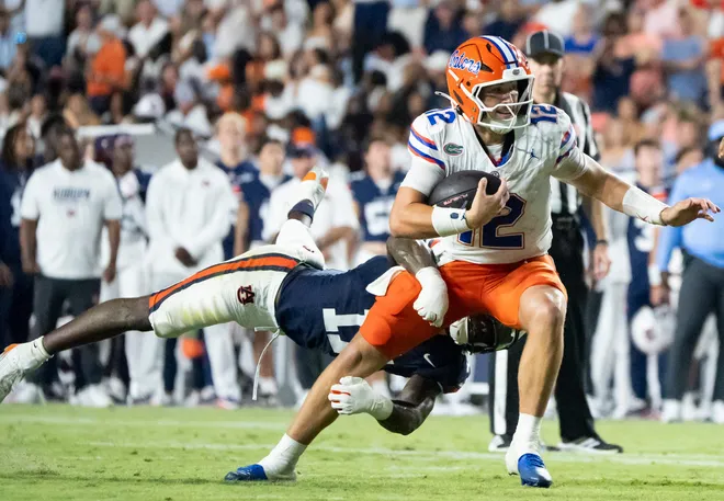 Florida Gators quarterback Aaron Philo (12) is sacked by Auburn Tigers linebacker Xavier Atkins (17) as Auburn Tigers take on Florida Gators at Jordan-Hare Stadium in Auburn, Ala. on Saturday, Sept. 19, 2026. Florida Gators lead Auburn Tigers 20-17 at halftime.