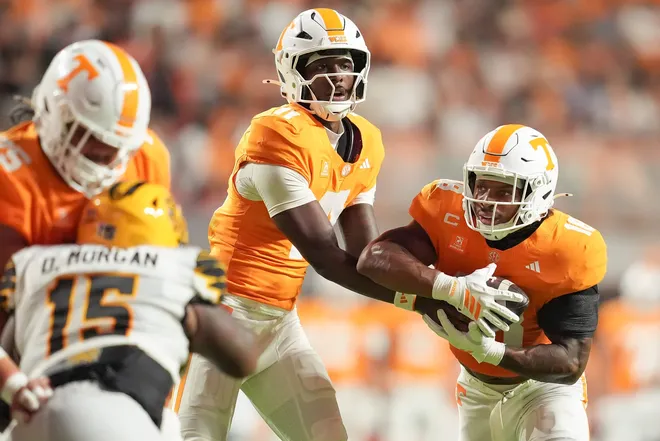 Tennessee quarterback Faizon Brandon (11) hands the ball off to Tennessee running back DeSean Bishop (18) during Tennessee’s college football game against Kennesaw State at Neyland Stadium in Knoxville on Sept. 19, 2026.