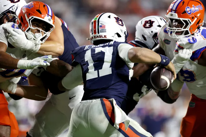 Sep 19, 2026; Auburn, Alabama, USA;  The Florida Gators defense closes in on Auburn Tigers quarterback Byrum Brown (17) during the fourth quarter at Jordan-Hare Stadium.  Mandatory Credit: John Reed-Imagn Images
