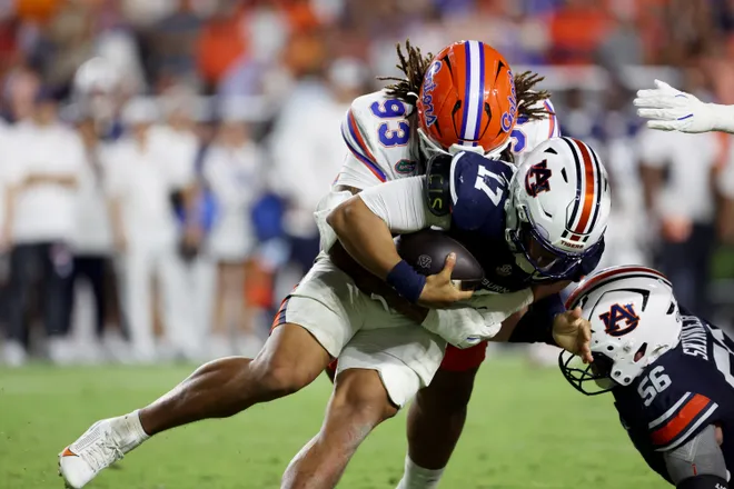 Sep 19, 2026; Auburn, Alabama, USA;  Auburn Tigers quarterback Byrum Brown (17) is sacked by Florida Gators defensive lineman Dk Kalu (93) during the fourth quarter at Jordan-Hare Stadium.  Mandatory Credit: John Reed-Imagn Images