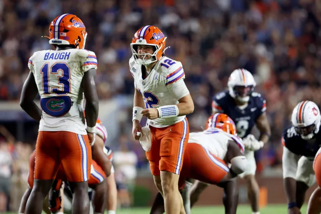 Sep 19, 2026; Auburn, Alabama, USA;  Florida Gators quarterback Aaron Philo (12) talks with running back Jadan Baugh (13) during the third quarter against the Auburn Tigers at Jordan-Hare Stadium.  Mandatory Credit: John Reed-Imagn Images